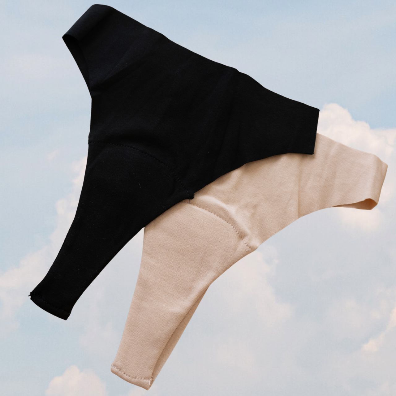 Black and beige Fredgies against a light blue sky