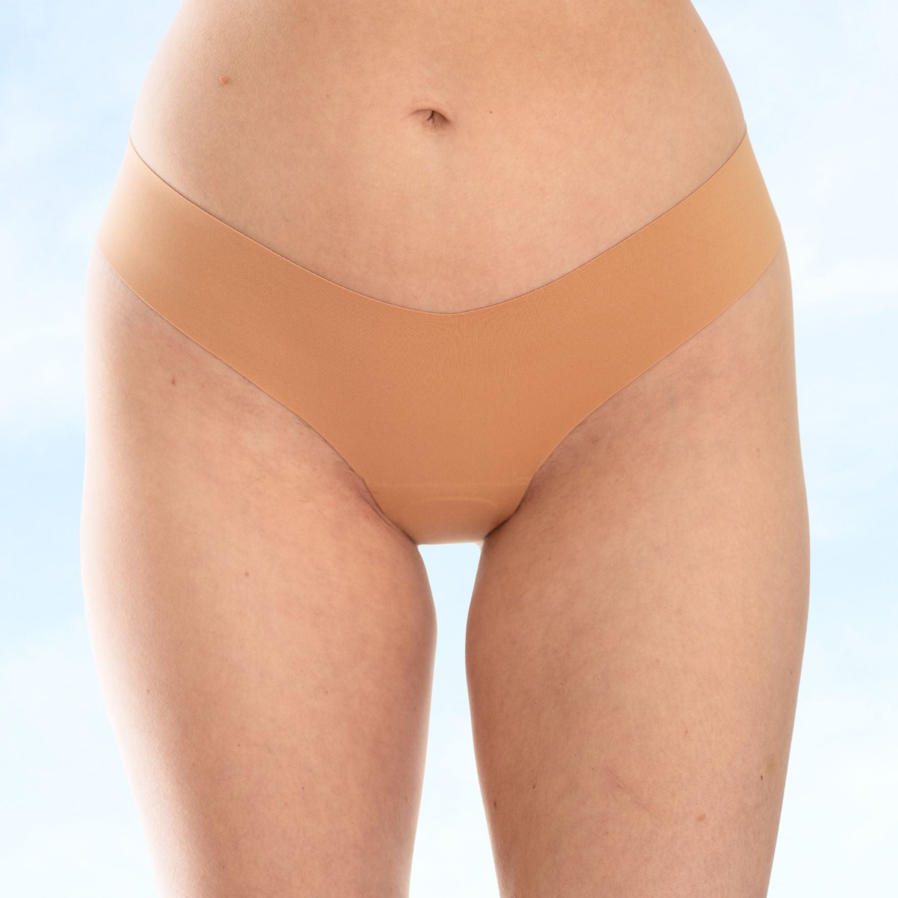 Tan underwear worn by a person on a light blue background