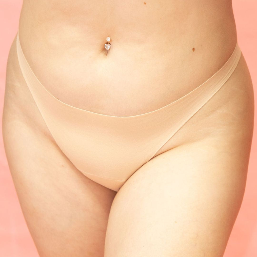 Beige thong on a pink background