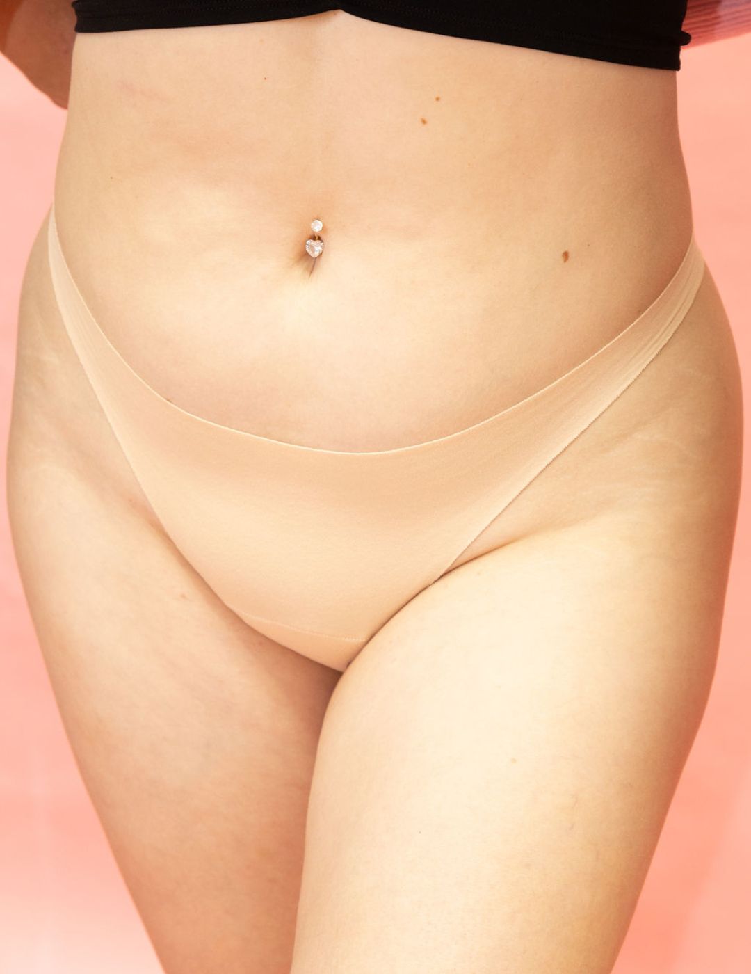 Beige thong on a pink background