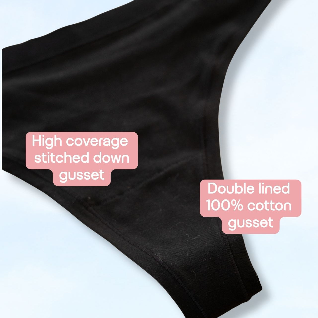 Black underwear gusset detail shot on a light blue background with two pink text callouts reading 'High coverage stitched down gusset' and 'Double lined 100% cotton gusset'.