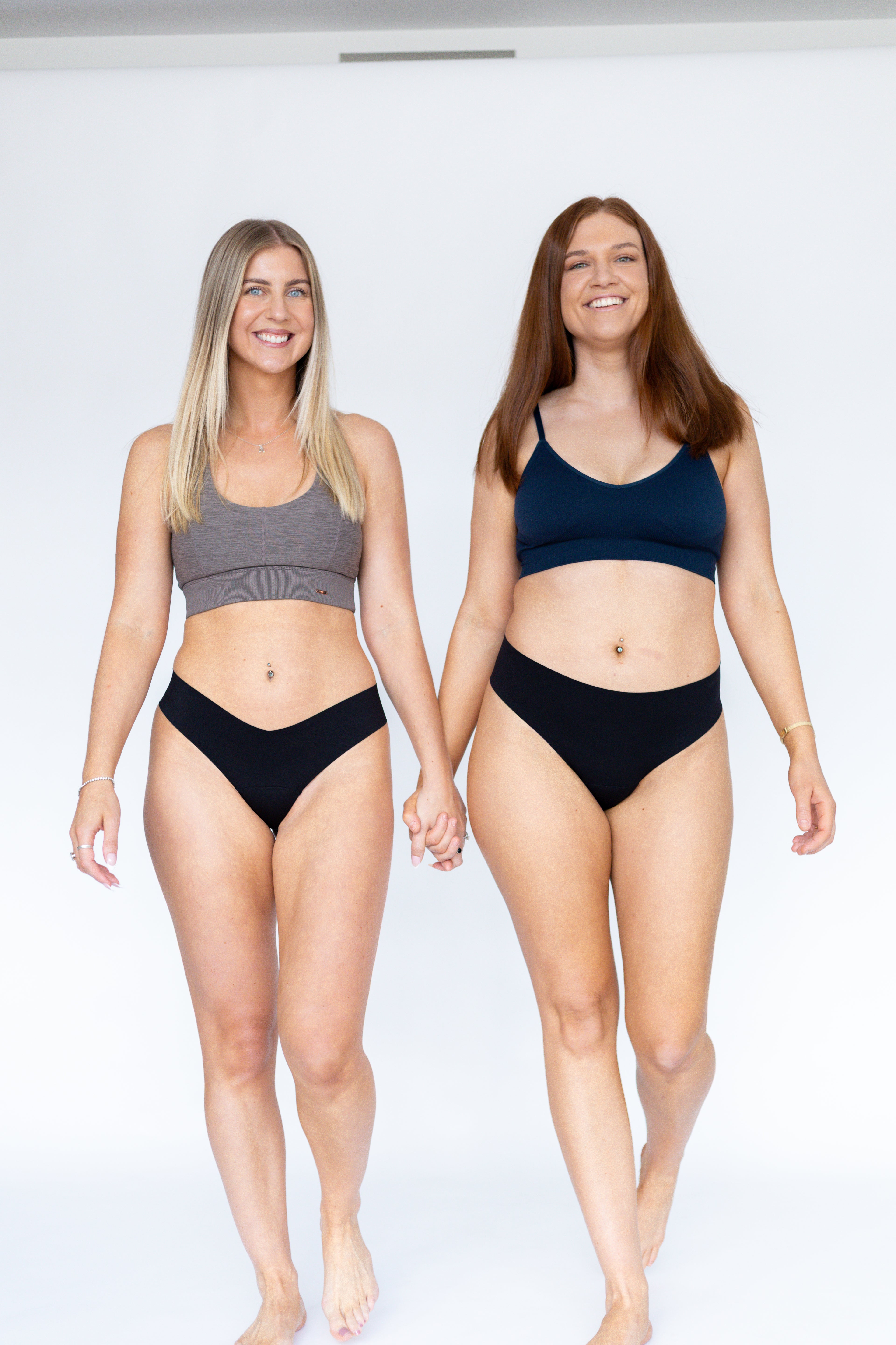 Two woman holding hands wearing Fredgies