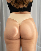 Model wearing black seamless Fredgies thong facing backwards