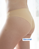 Beige underwear worn by a person on a white background with 'Size small' label.
