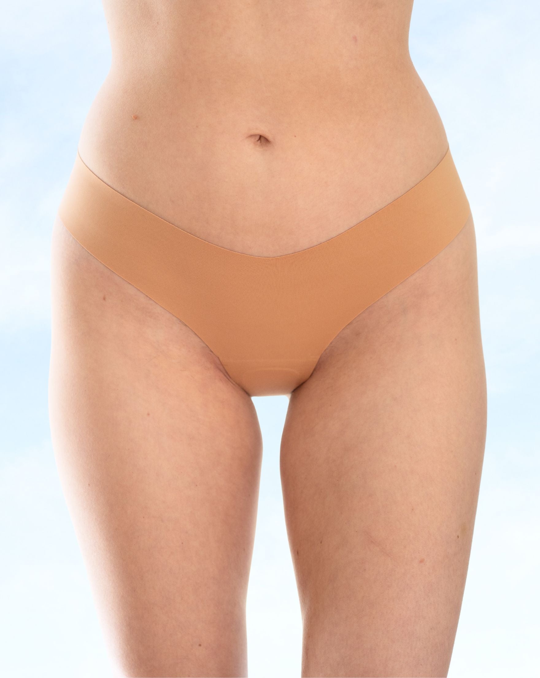 Tan underwear worn by a person on a light blue background