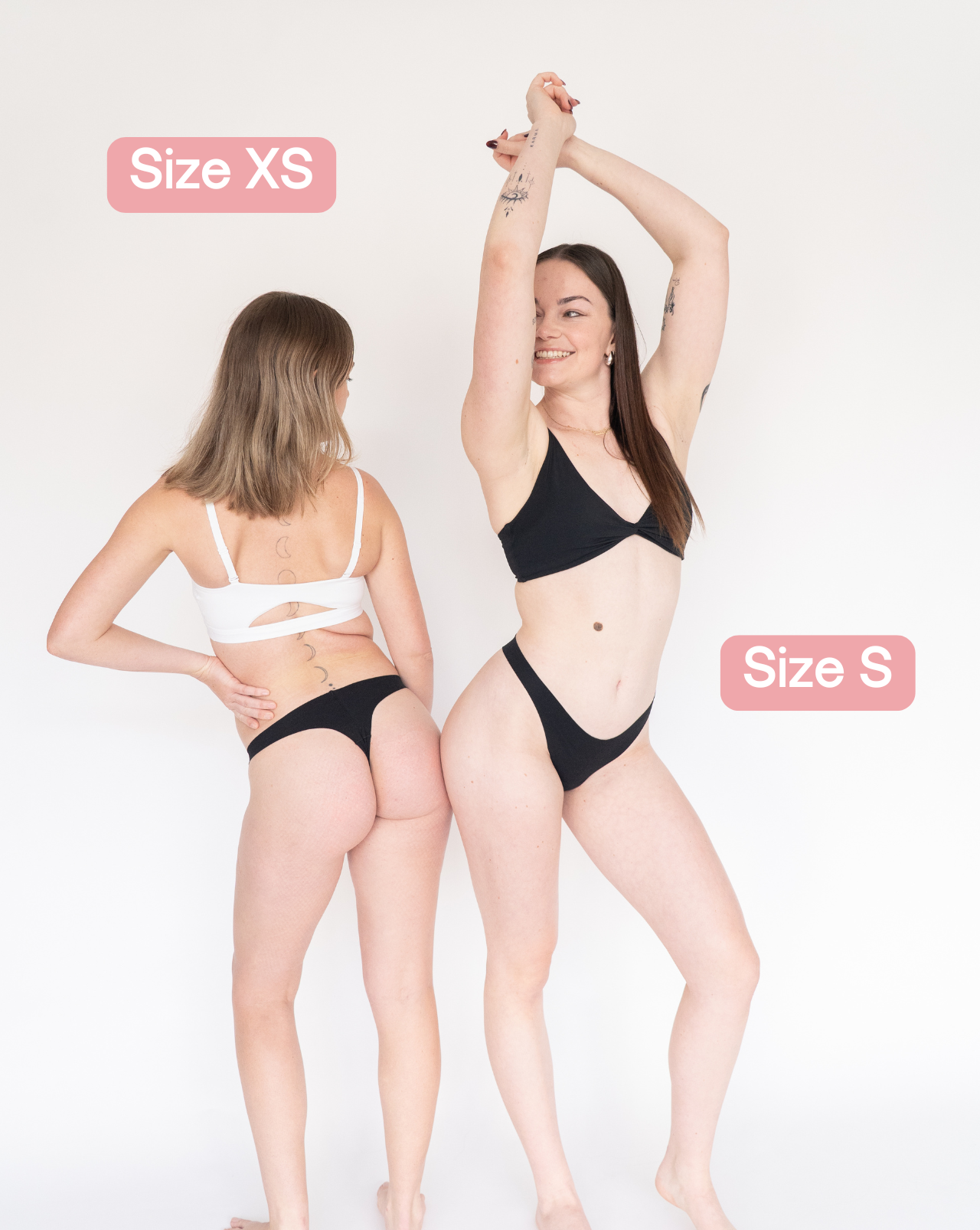 Two models wearing black Lite Fredgies