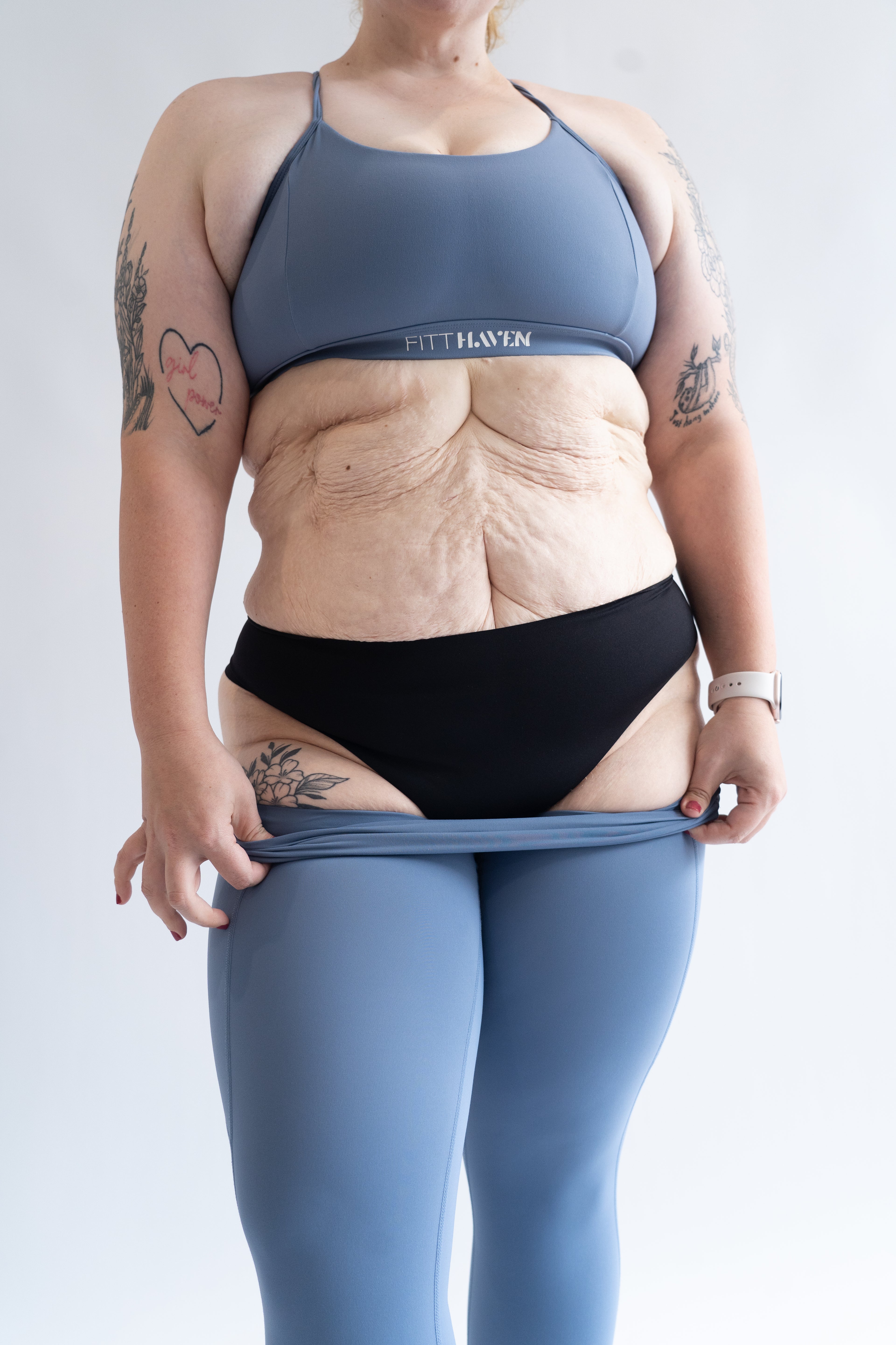 Woman revealing black Fredgies under leggings